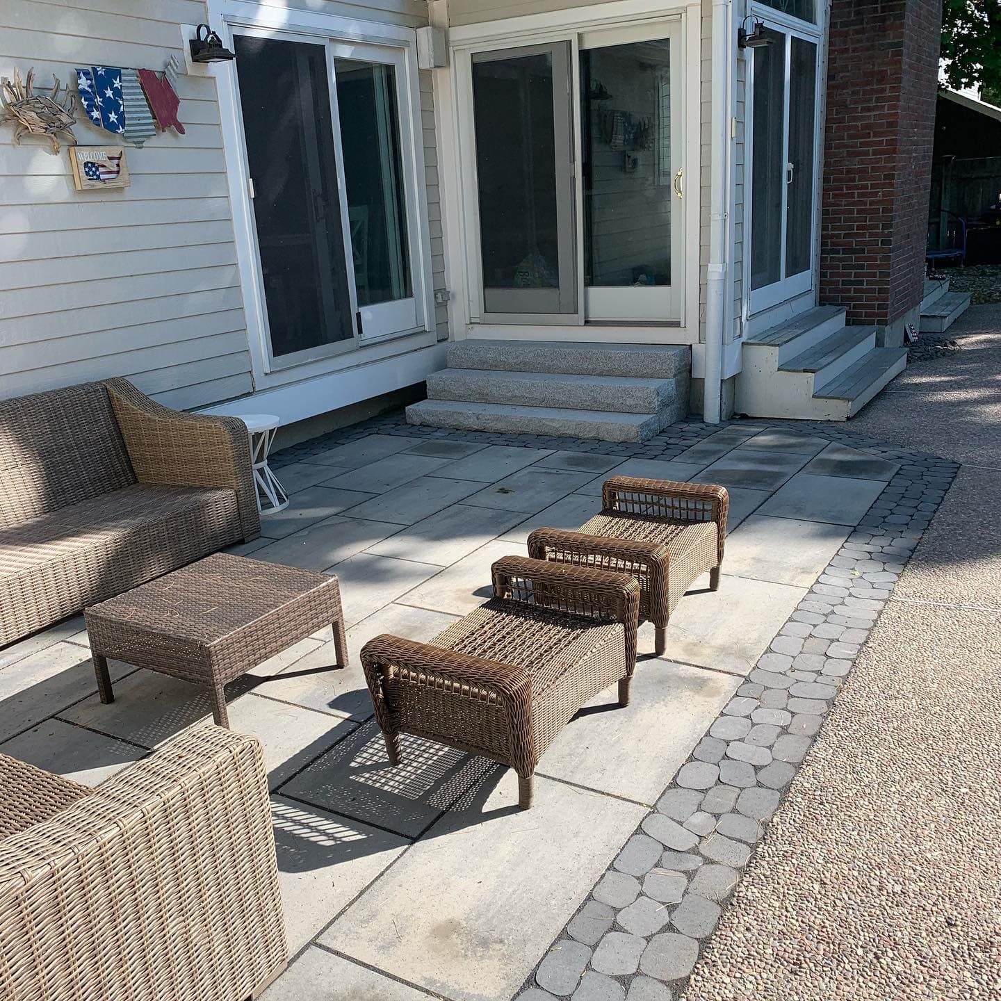 Bluestone-look patio with a cobble paver border and outdoor furniture