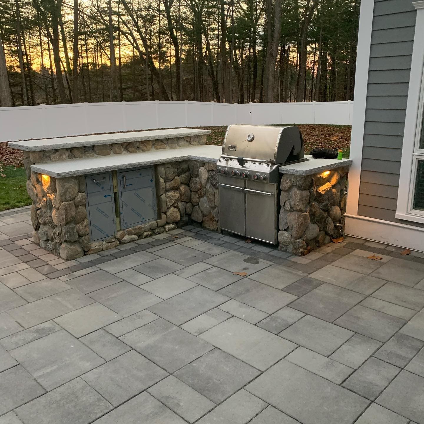 Outdoor grill station with stone base and granite counter
