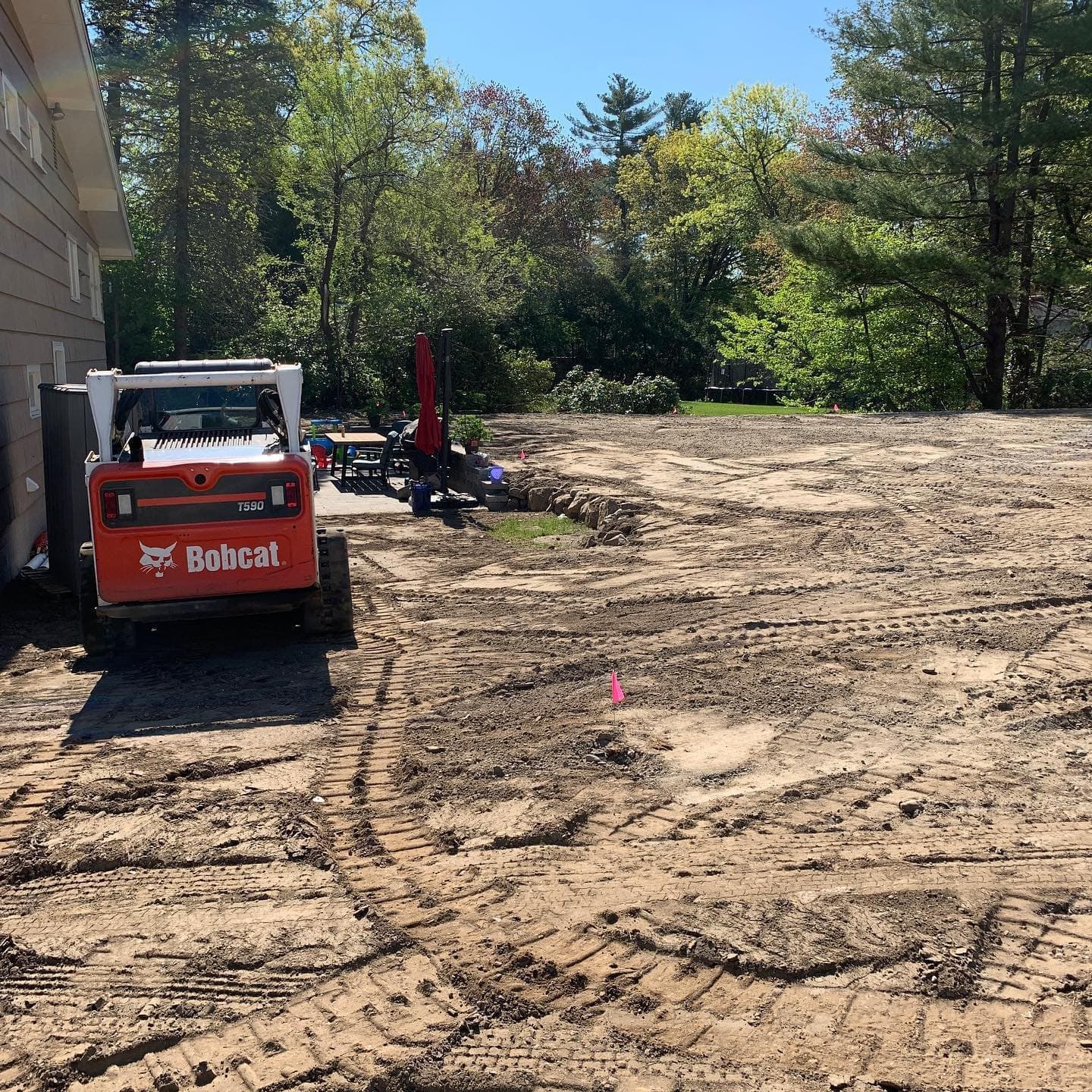 Skid steer regrading a backyard