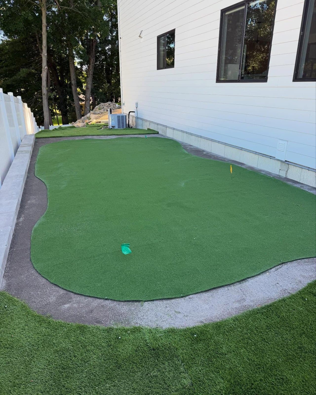 Artificial putting green beside a house