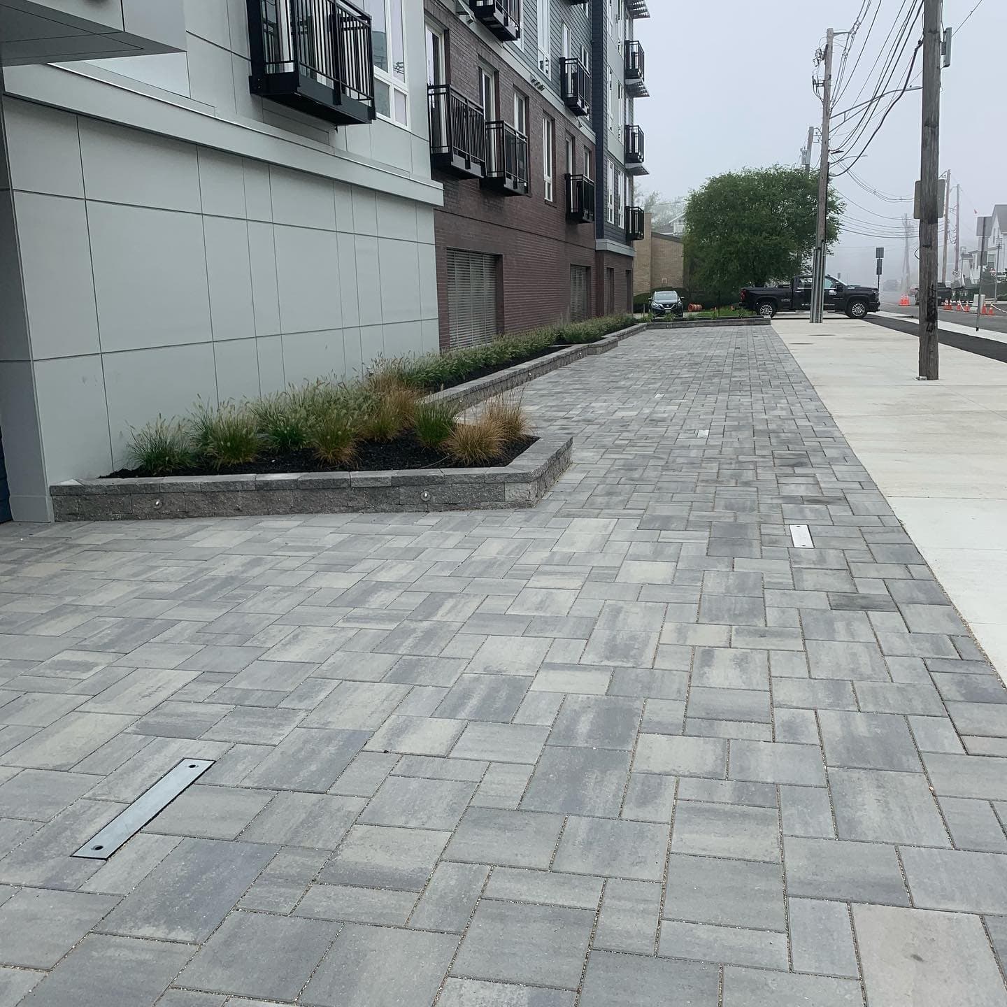 Commercial paver sidewalk along a new building