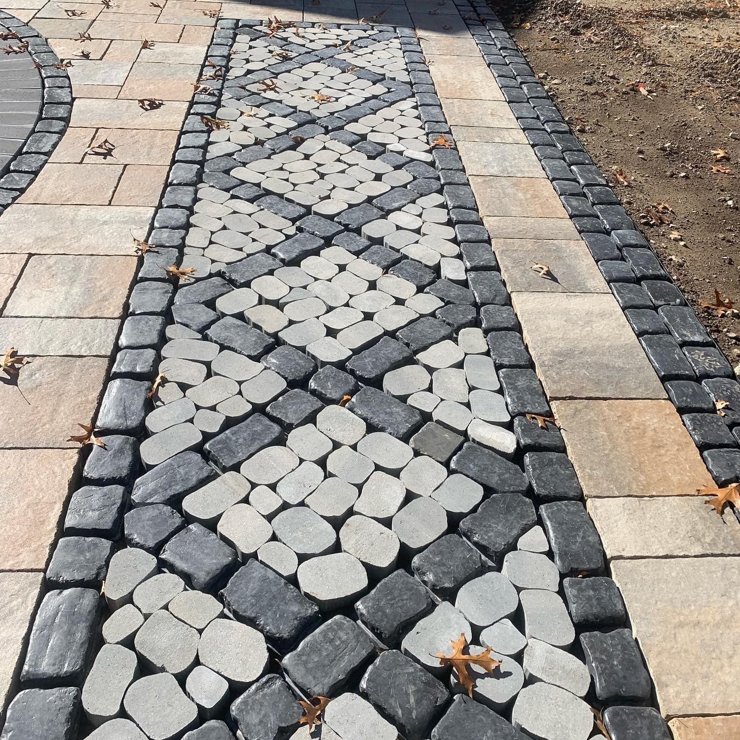 Close-up of a decorative cobble paver pattern in a walkway