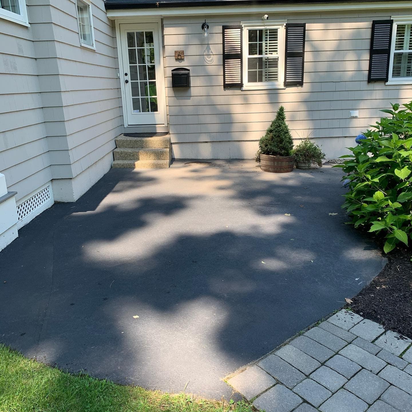 Gray paver front walk edged with pavers along a driveway