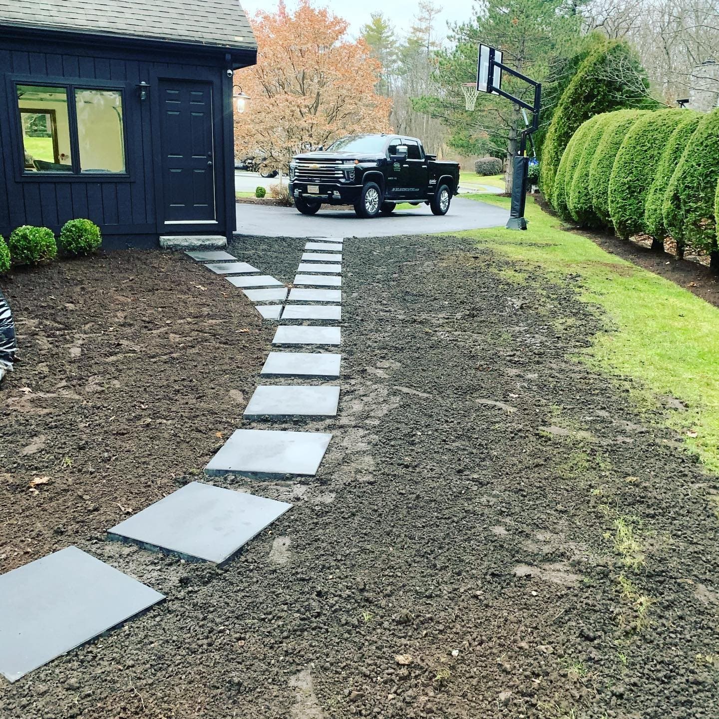 Bluestone stepping stones set in a new lawn along a driveway