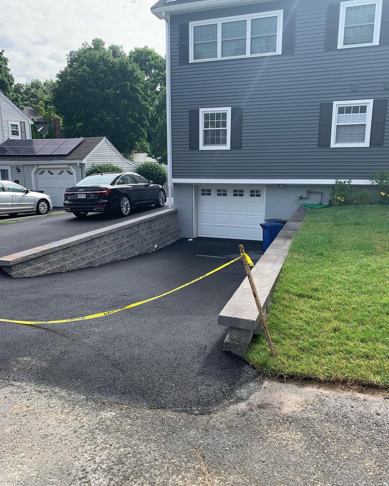 Low retaining wall along the edge of a driveway