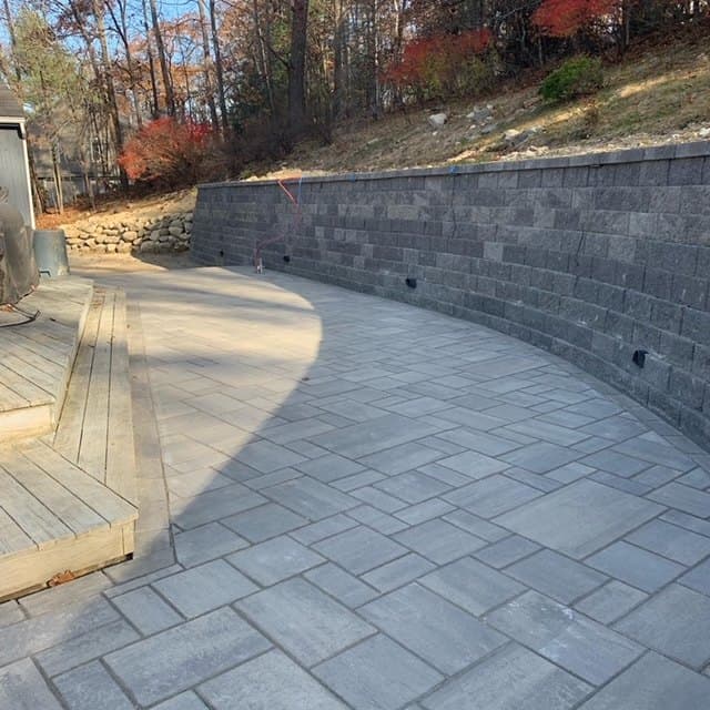 Finished curved block wall above a paver patio