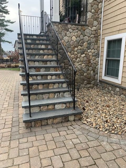Stone stairway ending on a paver walk